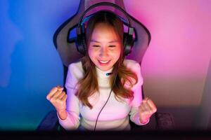 ásia jogador jogando conectados vídeo jogos ganhando animado em pc com iluminação efeito, transmissão transmissão viver às lar. jogador e e-sport conectados jogos tecnologia campeonato torneio jogador conceito. foto