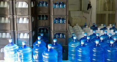 o galão de água azul contendo água potável foi lacrado com um lacre de plástico na estação de tratamento de água potável para aguardar a entrega foto