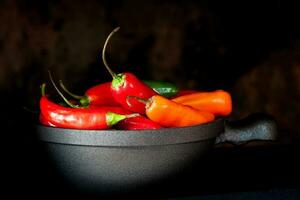 vermelho quente Pimenta pimentas em Preto fundo foto