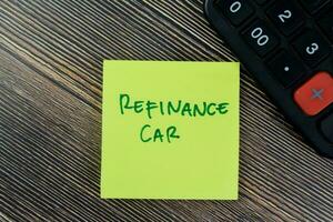 conceito do refinanciar carro escrever em pegajoso notas isolado em de madeira mesa. foto