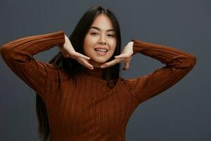 bonita mulher mão gestos Castanho suéter moda estúdio modelo foto