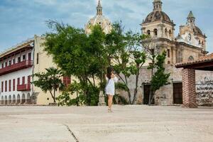 lindo mulher levando As fotos com dela celular às a paredes em torno da a colonial cidade do cartagena de índias