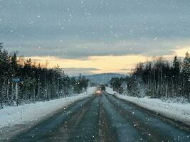 tarde inverno neve estrada em a cola Península. tráfego do carros. foto