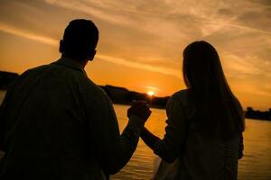 uma jovem casal sobre a pôr do sol foto