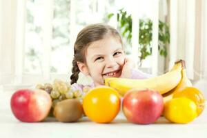 pequeno menina com frutas para saúde e bem estar conceito foto