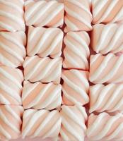 doces marshmallows rosa com tiras brancas foto