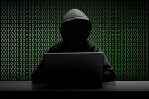 misterioso homem vestindo Preto moletom com capuz usando computador portátil dentro a Sombrio sala. hacker e cyber segurança conceito. foto