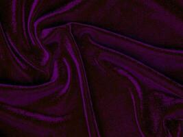 textura de tecido de veludo roxo usada como plano de fundo. fundo de tecido roxo vazio de material têxtil macio e liso. há espaço para o texto. foto