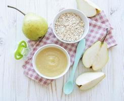 tigela com papinha de fruta e peras foto