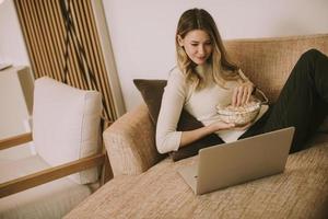 jovem mulher bonita usando um laptop em casa