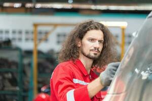 técnico homem trabalhando dentro auto serviço com levantado veículo, auto mecânico trabalhando dentro garagem, carro reparar, e manutenção foto