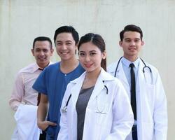 sul leste ásia jovem malaio chinês homem mulher médico médico estetoscópio avental grupo ficar de pé pose confiante foto