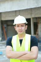 sul leste ásia jovem malaio chinês homem mulher vestindo em segurança capacete construção local trabalhos foto