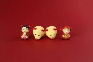 chinês Novo ano rato rato em forma bolacha Garoto menina boneca em vermelho fundo foto