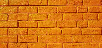 padronizar amarelo tijolo parede pintado para fundo. arte papel de parede e arquitetura exterior Projeto conceito foto