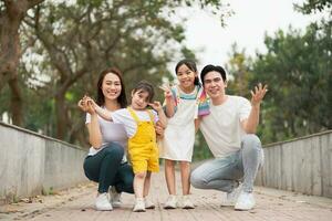 jovem ásia família dentro a parque foto