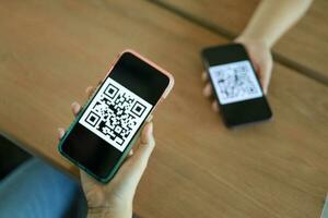 qr código pagamento. mulher digitalização qr código conectados compras sem dinheiro tecnologia conceito. foto