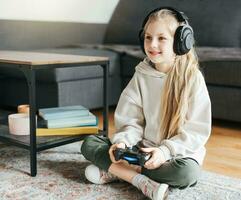 pequeno menina jogando em jogos console foto