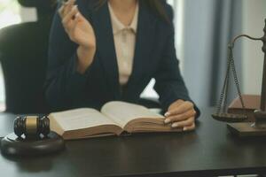 conceito de justiça e direito. juiz masculino em um tribunal com o martelo, trabalhando com, computador e teclado de encaixe, óculos, na mesa na luz da manhã foto