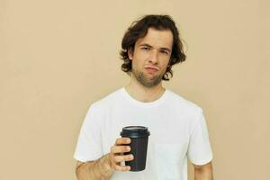 homem dentro uma branco camiseta com uma Preto vidro dentro mão estilo de vida inalterado foto