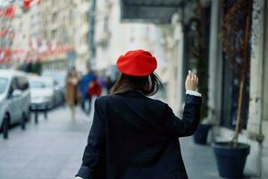 mulher felicidade Visão a partir de a voltar, Segue mim anda em anda em dentro a cidade contra a pano de fundo do escritório edifícios, à moda elegante vintage roupas e inventar, Primavera andar, viagem. foto