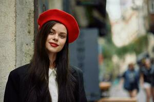 mulher sorrir moda modelo anda em em a rua dentro a cidade Centro entre a multidão dentro uma Jaqueta e vermelho boina e jeans, cinematográfico francês moda estilo roupas, viagem para Istambul Primavera foto