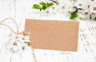 flor de cerejeira da primavera com um cartão em um fundo de madeira foto