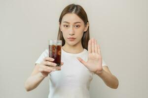 dieta, dieta. atraente ásia jovem mulher, menina empurrar Fora frio Cola, recusar carbonatado suave beber refrigerante, espumante água de dela mão. saúde Cuidado, saudável estilo de vida conceito, evitar limites doce açúcar. foto