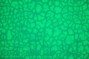 verde abstrato padronizar textura fundo com rachaduras e buracos. fechar acima. foto
