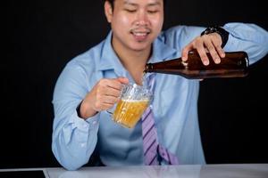 cortada de perto de um homem bebendo cerveja em casa foto