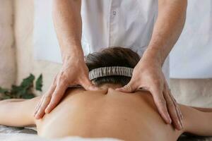 costas massagem dentro uma massagem salão, mulher tendo uma relaxante costas massagem. foto
