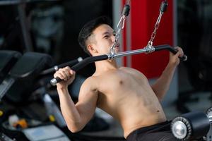 homem desportivo a treinar a fazer exercício no ginásio de fitness foto