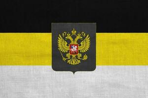 russo imperial bandeira com uma de duas cabeças Águia. a primeiro oficial Estado bandeira do a russo Império e a bandeira para celebrações em a textura. conceito colagem. foto