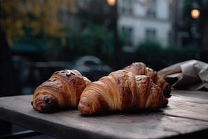 recentemente cozido croissants em a mesa dentro uma cafeteria. delicioso francês croissants com café em uma de madeira mesa, ai gerado foto