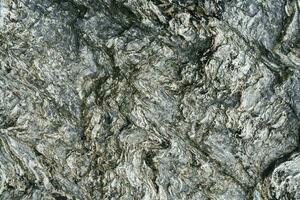 a rochoso textura do a velho mar pedra. foto