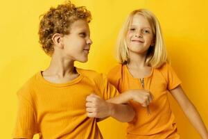 cenário do positivo Garoto e menina casual vestem jogos Diversão juntos posando em colori fundo foto