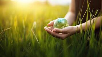 fêmea mãos aguarde a planeta contra a fundo do verde grama, ecologia e conservação tema. ai gerado foto