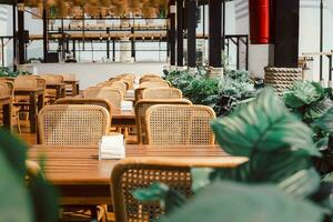 de madeira mesa e rattan cadeiras às aberto cafeteria ar livre. foto