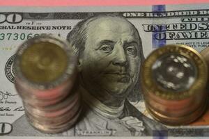 Argentino moedas com 100 dólares conta fundo foto
