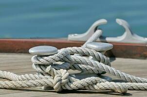 cordas amarrado acima para barco grampo foto