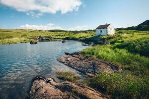 lindo panorama cenário com chalé de a rio em verde Prado às connemara nacional parque dentro município galway, Irlanda foto