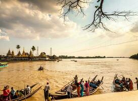 yangon, myanmar - jan 4, 2020 pessoas e turistas embarque uma pequeno barco, a só caminho para pegue para a Kyaik como wun pagode e têmpora em uma pequeno ilha dentro a rio às kyauktan cidade, yangon, myanmar foto