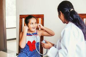 indiano médico tratando uma pequeno indiano menina foto