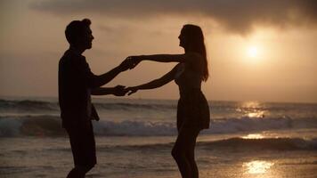 retrato de jovem casal dançando na praia foto