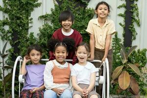 grupo engraçado pequeno feliz escola verão acampamento menina e dela amigos relaxante foto