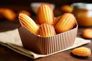 madeleines caixa dentro a cozinha mesa Comida fotografia ai gerado foto