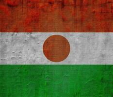 bandeira do república do Níger em uma texturizado fundo. conceito colagem. foto
