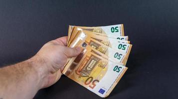 homem com notas de 50 euros foto