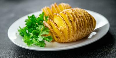 cozido batata fatia acordeão vegetal refeição Comida lanche em a mesa cópia de espaço Comida fundo rústico topo Visão foto