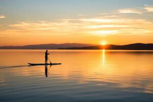 uma sereno tiro do uma paddleboarder planador através uma calma lago às nascer do sol. generativo ai foto